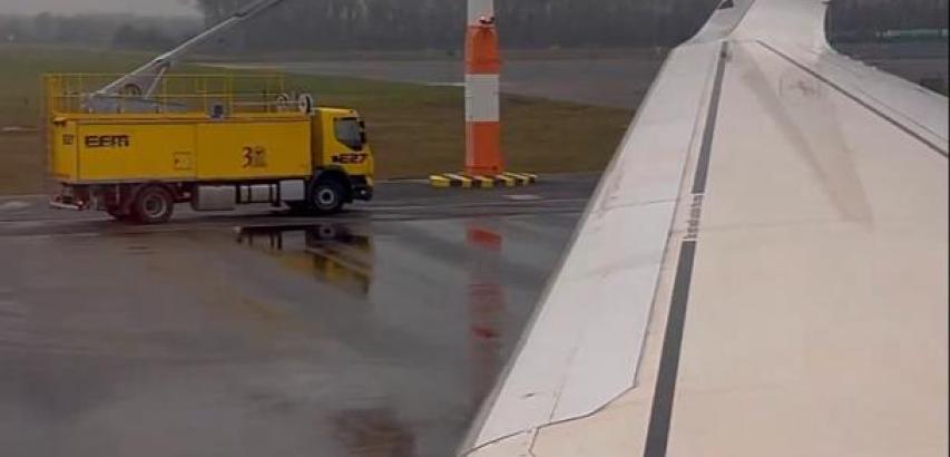 Spraying planes with a yellow material before takeoff
